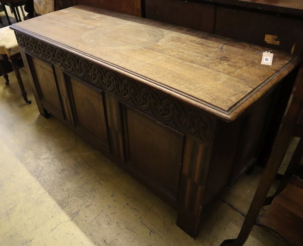 A 17th/18th century inlaid oak coffer with panelled front and planked top, width 145cm depth 53cm height 66cm